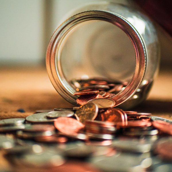 money jar small Pennies in a tipped jar. How has the Covid-19 pandemic affected credit management?
